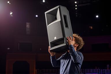 Speakers being installed in a large venue.